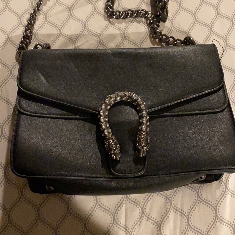 Black purse with diamond studded horshoe